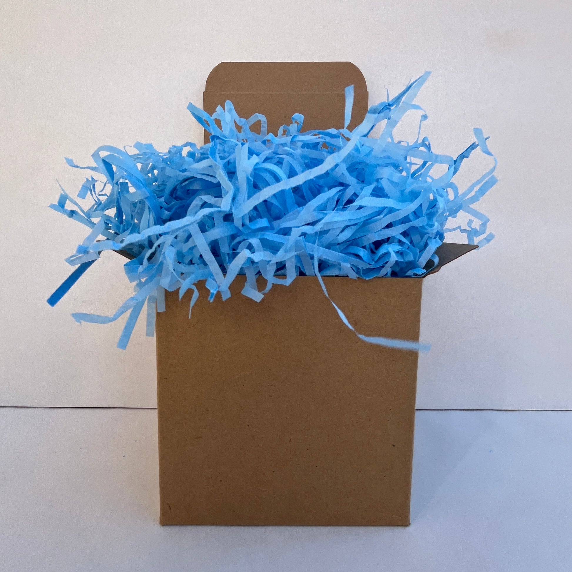 Blue shredded paper in gift box packaging eco friendly filler