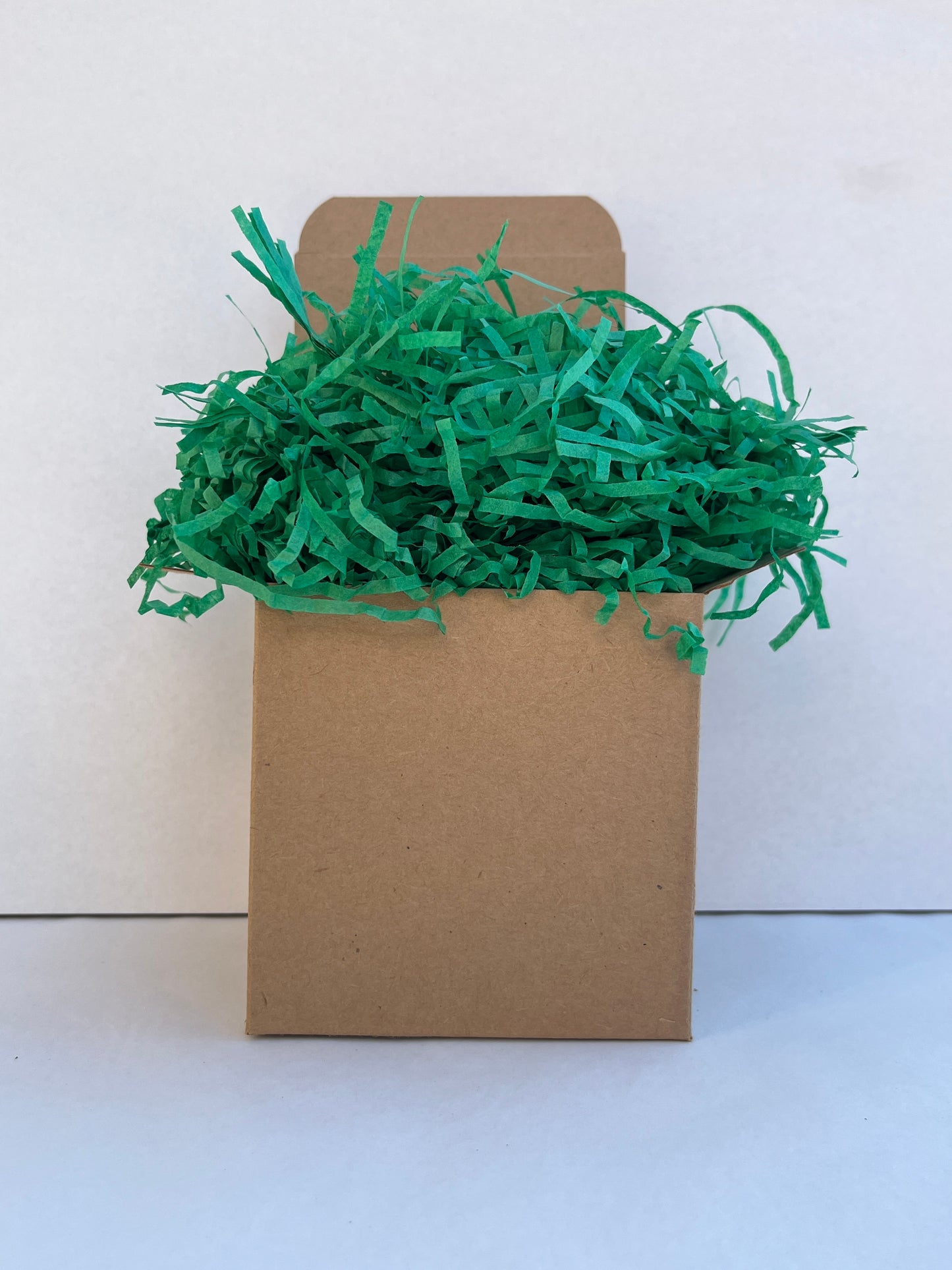 Green shredded paper in gift box packaging eco friendly filler