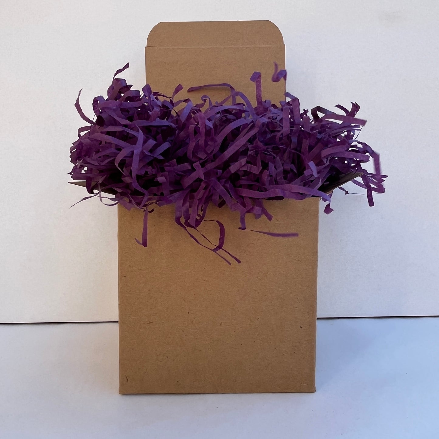 Purple shredded paper in gift box packaging eco friendly filler